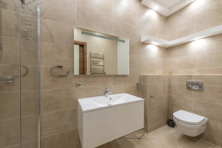 Clean modern bathroom with white sink and mirror
