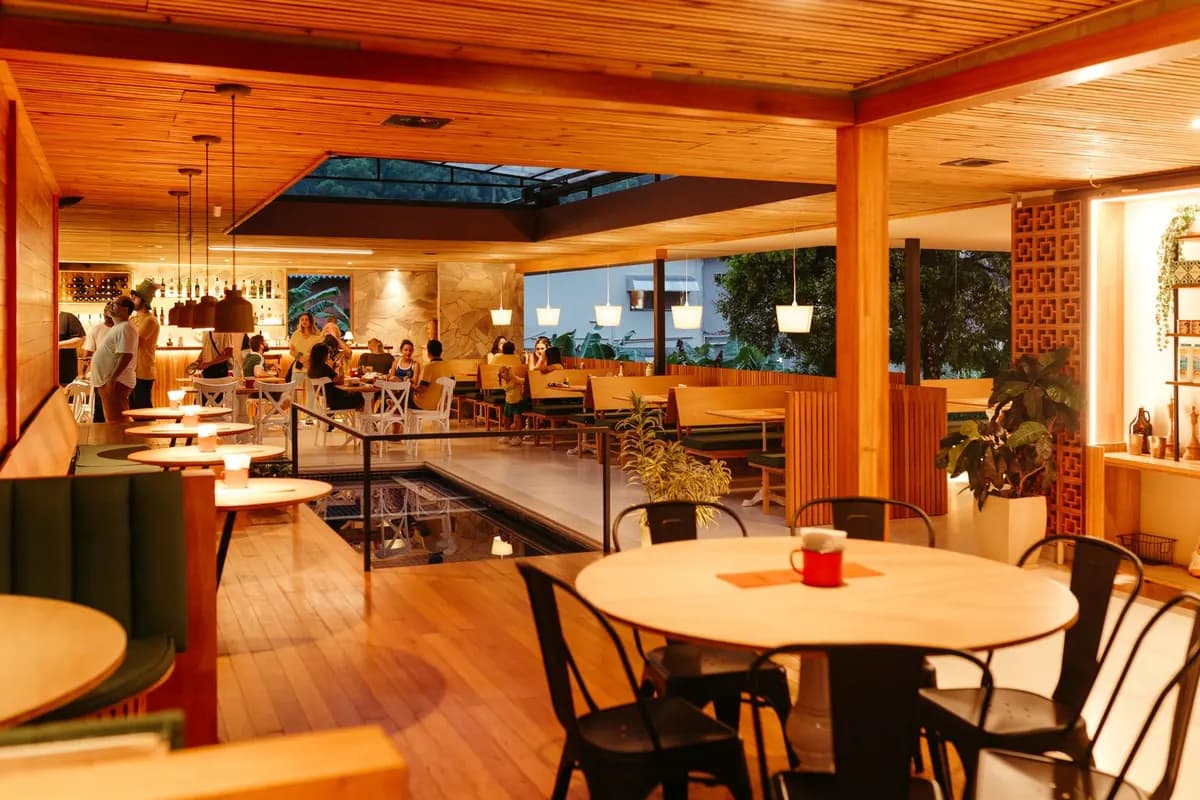 Warm restaurant dining room with wooden tables
