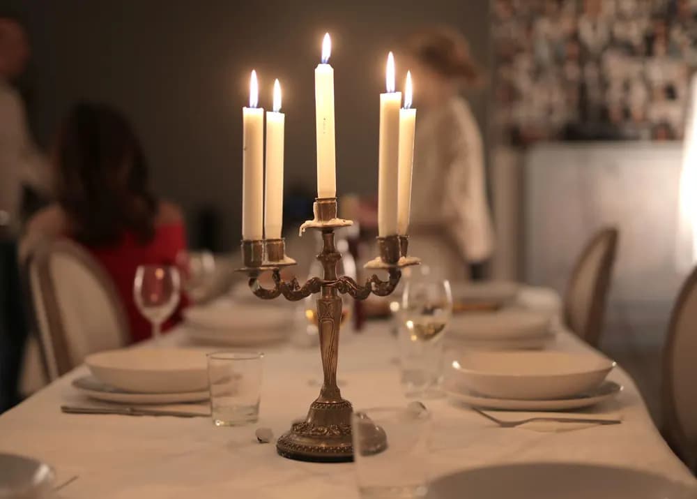 Candlelit restaurant table set for dinner