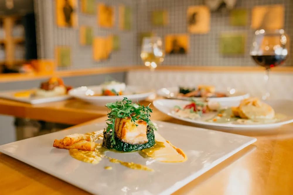 Restaurant table with shared dishes and wine